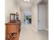 Elegant hallway with neutral walls and tile flooring leading to a modern kitchen and dining area at 13557 Parkfield Way, Winter Garden, FL 34787