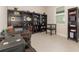 Organized home office featuring dark wood shelving and ample natural light from a window at 13557 Parkfield Way, Winter Garden, FL 34787
