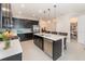 Modern kitchen with dark cabinetry, stainless steel appliances, a spacious island, and a walk-in pantry at 13557 Parkfield Way, Winter Garden, FL 34787