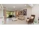 Bright living room features neutral tones, movie posters, and sliding glass doors to the patio at 13557 Parkfield Way, Winter Garden, FL 34787