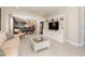 Open concept living room with white tile flooring, built-in shelving, and seamless flow to the dining room at 13557 Parkfield Way, Winter Garden, FL 34787