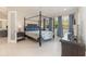 Spacious main bedroom with a four-poster bed, ensuite bathroom, and plenty of natural light at 13557 Parkfield Way, Winter Garden, FL 34787
