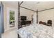 Comfortable main bedroom featuring a dark wood poster bed, television, and sliding glass door leading to the outdoor patio at 13557 Parkfield Way, Winter Garden, FL 34787