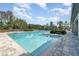 Beautiful community pool surrounded by lounging chairs and well-manicured landscaping at 13557 Parkfield Way, Winter Garden, FL 34787