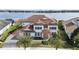 Luxury home with lake views, tile roof, and manicured landscaping at 15138 Shonan Gold Dr, Winter Garden, FL 34787