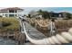Spacious backyard showcasing a wooden bridge leading to the main house, surrounded by beautiful landscaping at 15138 Shonan Gold Dr, Winter Garden, FL 34787