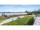 Stunning backyard features a waterfront view, outdoor fire pit, dock, and inviting lounge area at 15138 Shonan Gold Dr, Winter Garden, FL 34787