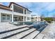 Lush backyard with a pool featuring a waterfall, outdoor kitchen, and lounge area, perfect for entertaining at 15138 Shonan Gold Dr, Winter Garden, FL 34787
