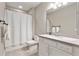 Neutral bathroom with a tub and shower, white vanity and mirror at 15138 Shonan Gold Dr, Winter Garden, FL 34787