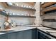 Well-organized butler's pantry with custom cabinets and shelves for storage and preparation at 15138 Shonan Gold Dr, Winter Garden, FL 34787