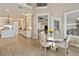 Open-concept dining area with wood-look tile flooring and adjacent kitchen and living spaces at 15138 Shonan Gold Dr, Winter Garden, FL 34787