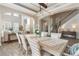 Open-concept dining room with natural light and views into the living area and staircase at 15138 Shonan Gold Dr, Winter Garden, FL 34787