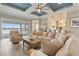 Comfortable living room features lake views, a modern ceiling design, and seamless indoor-outdoor living at 15138 Shonan Gold Dr, Winter Garden, FL 34787