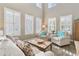 Bright living room featuring high ceilings, large windows, and comfortable seating at 15138 Shonan Gold Dr, Winter Garden, FL 34787