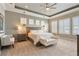 Serene main bedroom suite with patterned wallpaper, tray ceilings, and natural light at 15138 Shonan Gold Dr, Winter Garden, FL 34787