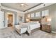 Bright main bedroom suite with sitting area, tray ceiling, and serene ambiance at 15138 Shonan Gold Dr, Winter Garden, FL 34787