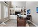 Home office with built-in bookshelves, a large desk, and a comfortable executive chair at 15138 Shonan Gold Dr, Winter Garden, FL 34787