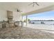 Outdoor kitchen with grill, bar seating, and water views perfect for cooking and entertaining outdoors at 15138 Shonan Gold Dr, Winter Garden, FL 34787
