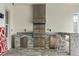 Outdoor kitchen with grill, bar seating, and water views perfect for cooking and entertaining outdoors at 15138 Shonan Gold Dr, Winter Garden, FL 34787