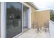 Private balcony with patio furniture and sliding glass doors at 1534 Tranquil Ave, Clermont, FL 34714