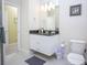 Updated bathroom with granite countertop, white cabinets, and tile floor at 1534 Tranquil Ave, Clermont, FL 34714