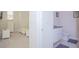 Small bathroom with toilet and vanity; adjacent to bedroom at 1534 Tranquil Ave, Clermont, FL 34714