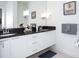 Bathroom boasts a double vanity and dark countertop at 1534 Tranquil Ave, Clermont, FL 34714
