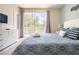 Main bedroom with king bed and private balcony at 1534 Tranquil Ave, Clermont, FL 34714
