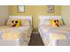 Welcoming bedroom with two twin beds and yellow walls at 1534 Tranquil Ave, Clermont, FL 34714