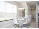 Modern dining room with white table and chairs near kitchen at 1534 Tranquil Ave, Clermont, FL 34714