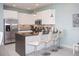 Modern kitchen with island, stainless steel appliances, and granite countertops at 1534 Tranquil Ave, Clermont, FL 34714