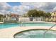 Community pool and hot tub with lounge chairs at 1534 Tranquil Ave, Clermont, FL 34714