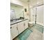 Bathroom with a glass-enclosed shower, granite countertop, and tile flooring at 1700 Tropical Palms Cir, Kissimmee, FL 34747