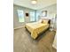 Cozy bedroom features plush carpeting, two windows, and bright yellow bedding at 1700 Tropical Palms Cir, Kissimmee, FL 34747