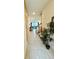 Hallway with tile flooring, leading to living spaces and filled with natural light at 1700 Tropical Palms Cir, Kissimmee, FL 34747