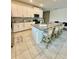 A large kitchen island with bar stool seating, stainless steel appliances, and a modern design at 1700 Tropical Palms Cir, Kissimmee, FL 34747