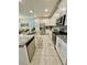 Modern kitchen featuring white cabinets, stainless steel appliances, and granite countertops with tile flooring at 1700 Tropical Palms Cir, Kissimmee, FL 34747