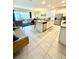 Open-concept kitchen and living room with a breakfast bar, stainless appliances, and lots of seating space at 1700 Tropical Palms Cir, Kissimmee, FL 34747