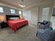 Comfortable main bedroom featuring tray ceiling, plush carpeting, and bright natural light at 1700 Tropical Palms Cir, Kissimmee, FL 34747