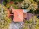Aerial view of a home with a tile roof surrounded by mature trees at 2004 Magnolia Ave, Sanford, FL 32771