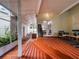 Large back porch with wood and brick flooring, a seating area, and access to a screened-in area at 2004 Magnolia Ave, Sanford, FL 32771