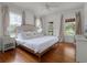 Bright bedroom with hardwood floors and large windows offering views of the surrounding foliage at 2004 Magnolia Ave, Sanford, FL 32771