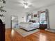 A spacious bedroom with hardwood floors features neutral decor, a ceiling fan, and abundant natural light at 2004 Magnolia Ave, Sanford, FL 32771