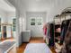 Bright closet featuring wood floors, a clothing rack, shelving unit, and a large dresser with a window above at 2004 Magnolia Ave, Sanford, FL 32771