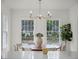 Sunlit dining room with round wood table and chandelier at 2004 Magnolia Ave, Sanford, FL 32771