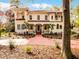 Elegant home with a terra cotta tile roof, arched details, and a walkway leading to a covered front porch at 2004 Magnolia Ave, Sanford, FL 32771