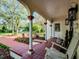 Charming front porch featuring decorative columns, outdoor seating, and a welcoming entrance at 2004 Magnolia Ave, Sanford, FL 32771