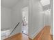 Hallway featuring hardwood floors and open doorways to reveal the home's layout at 2004 Magnolia Ave, Sanford, FL 32771