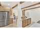 Bright kitchen featuring wooden cabinets, stainless appliances, white countertops, decorative beams, and dining area at 2004 Magnolia Ave, Sanford, FL 32771