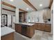 Spacious kitchen featuring wood cabinets, stainless steel appliances, and an island with a sink at 2004 Magnolia Ave, Sanford, FL 32771